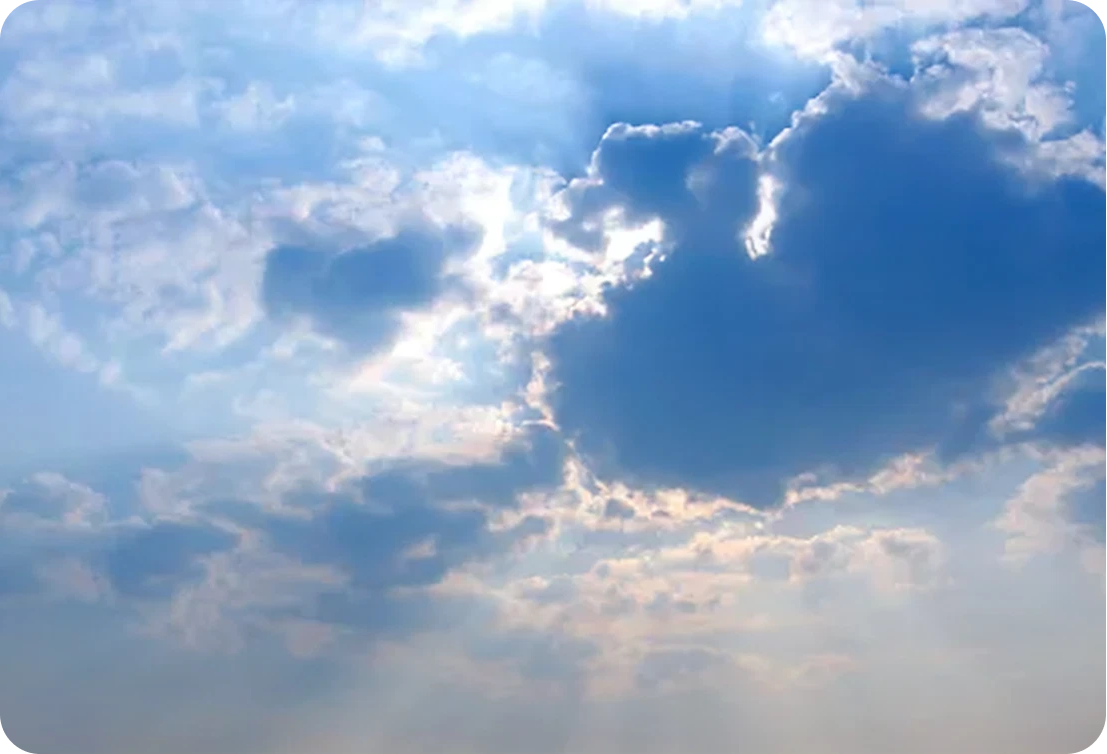 Sunlight breaking through fluffy clouds