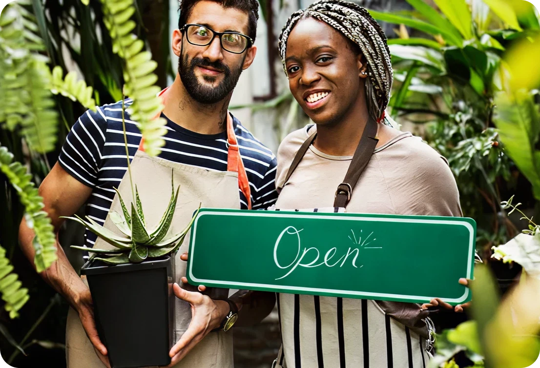 Plant shop employees welcoming customers
