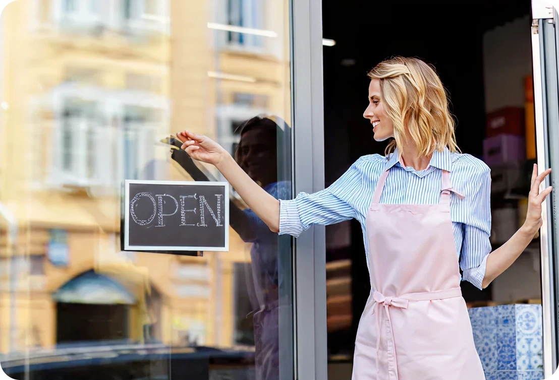 Female shopkeeper welcoming customers